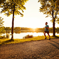 Healthy man running in park during sunset