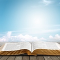 Open book on old wooden table