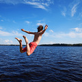 Young man jumping into water, summer time