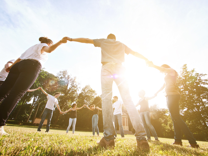 Group of friends holding hands together showing unity