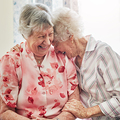 Shot of two happy elderly women spending time with each other at home