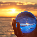 The sun sets over Lake Constance in Germany and lit by a crystal ball.