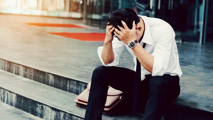 Unemployed Tired or stressed businessman sitting on the walkway after work Stressed businessman concept