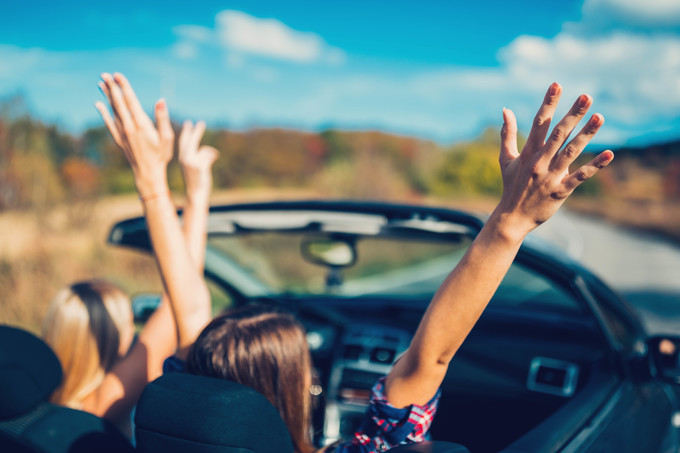 Friends on a road trip with cabriolet