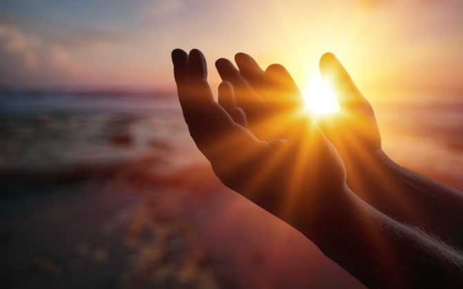 Silhouette person on sunset background. Raising his hands in worship. Christian Religion concept background.