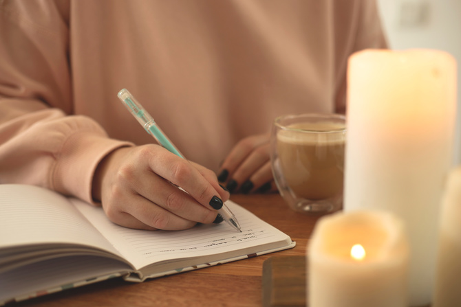 Woman writes in open notebook. Diary Concept for Psychological Health.