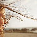 Cropped view of a young woman with the wind in her hair