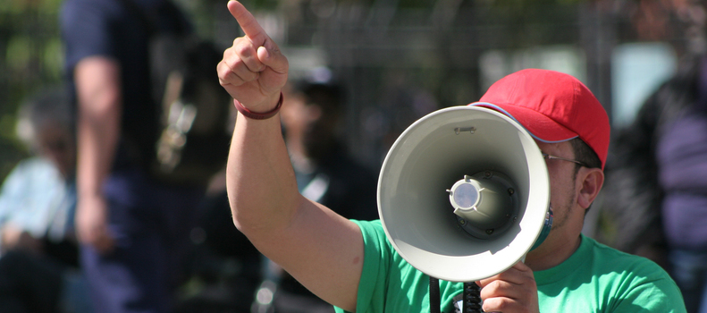 Protester pointing finger and holding megaphone