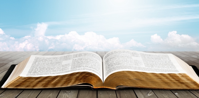 Open book on old wooden table