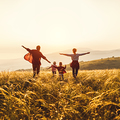Happy family: mother, father, children son and  daughter runing and jumping on nature  on sunset