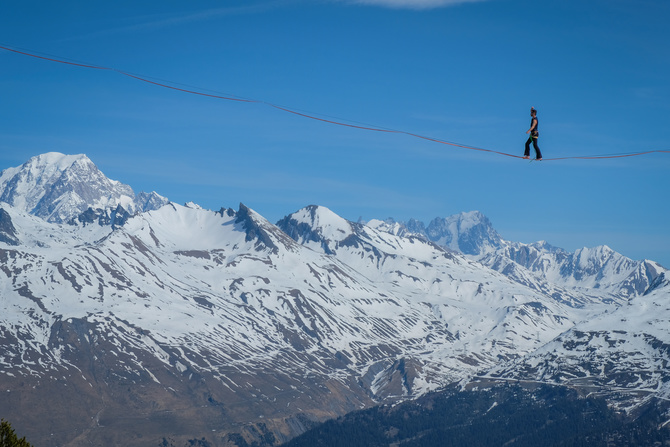 BOURG-SAINT-MAURICE, FRANCE - APRIL 07: a man walking on a highline in the French Alps, Auvergne-Rhône-Alpes, Bourg-Saint-Maurice, France on April 07, 2017 in Bourg-Saint-Maurice, France.